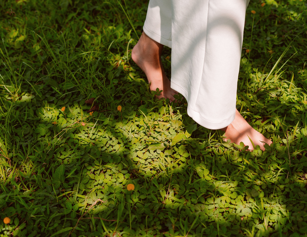 Female Feet Walking on Grass